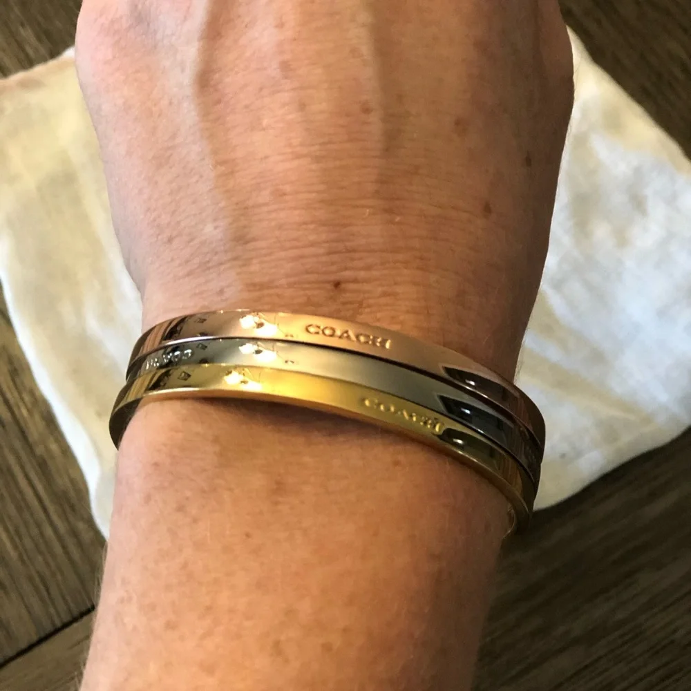 Coach bracelet set including a gold, silver and rose gold bangle. - Picture 3 of 3